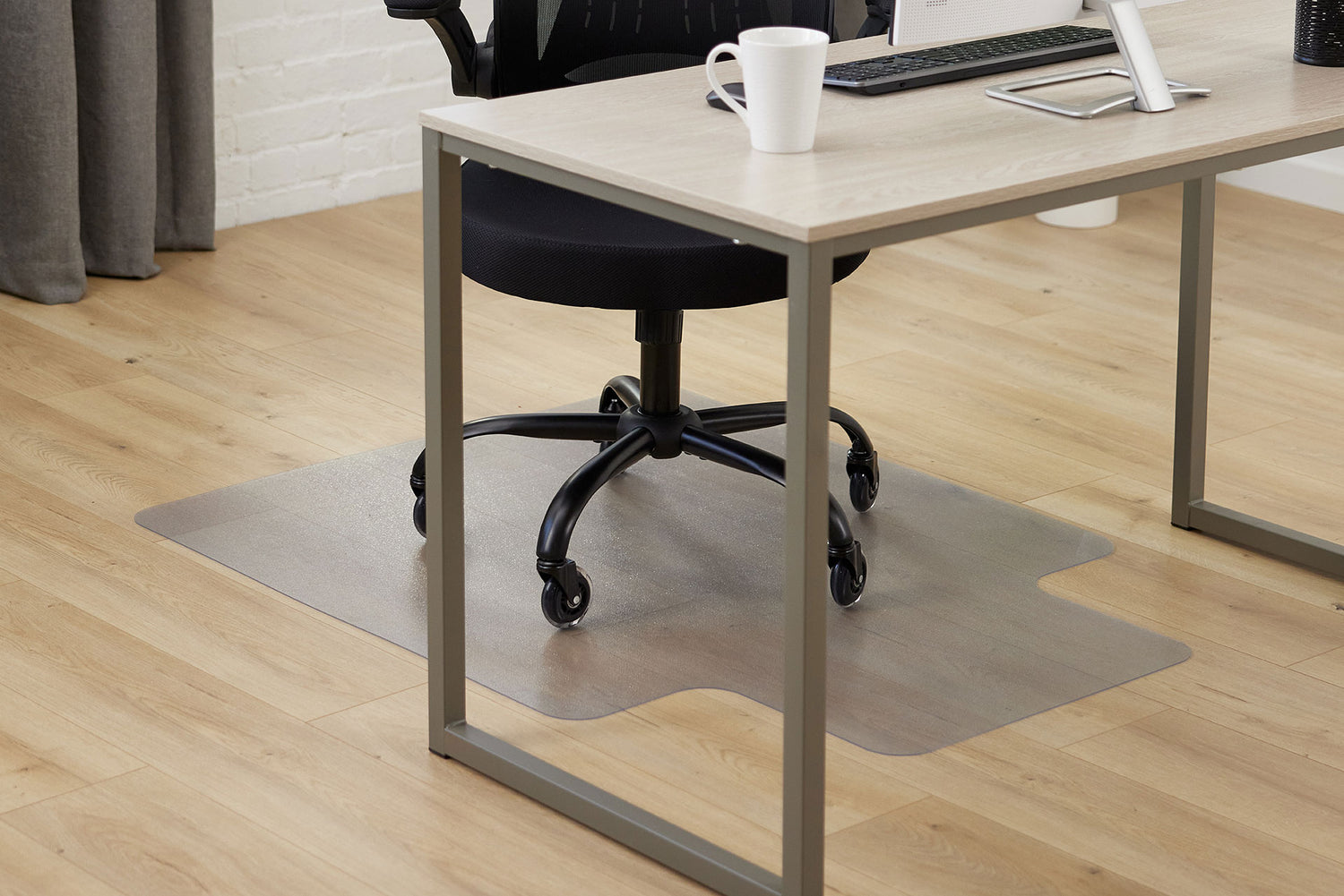 An office with a Gorilla Grip chair desk mat under a rolling chair for floor protection