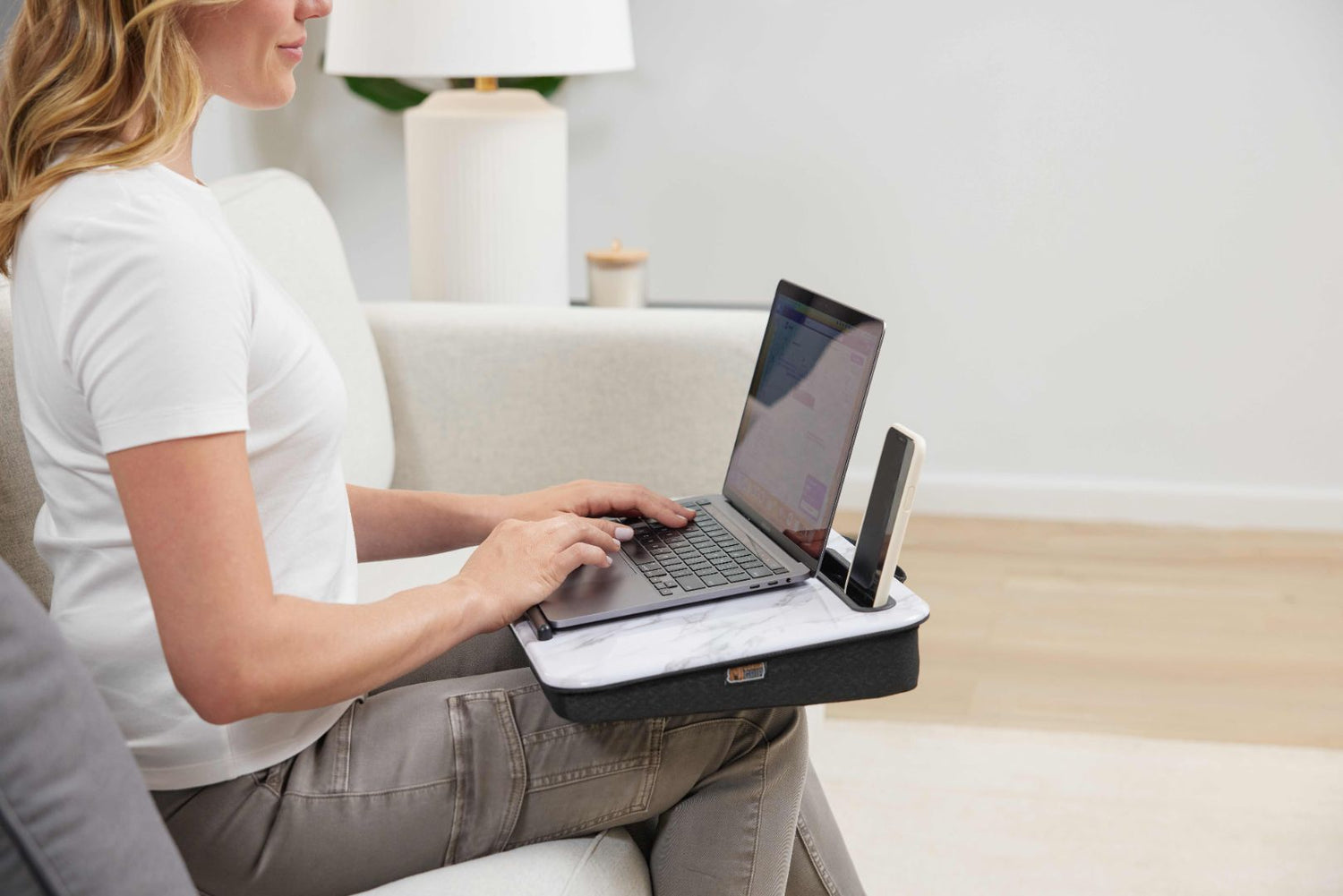 Woman using laptop on compact lap desk