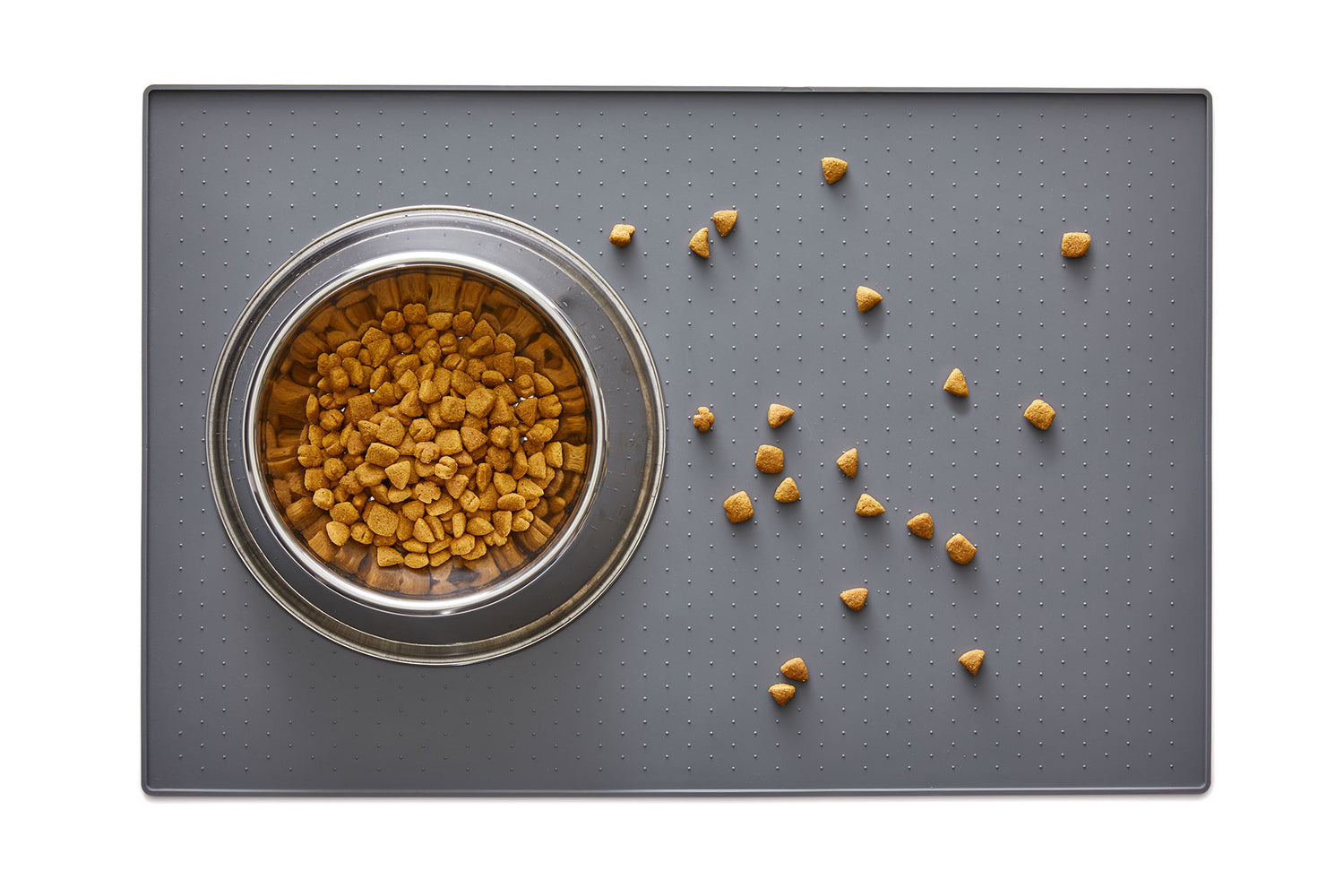 Pet food scattered on a Gorilla Grip feeding mat for less mess and floor protection