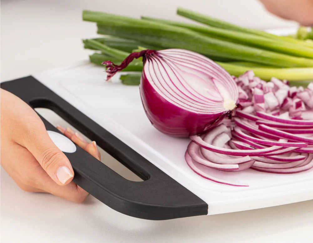 Red onion and other vegetables atop a Gorilla Grip Cutting Board